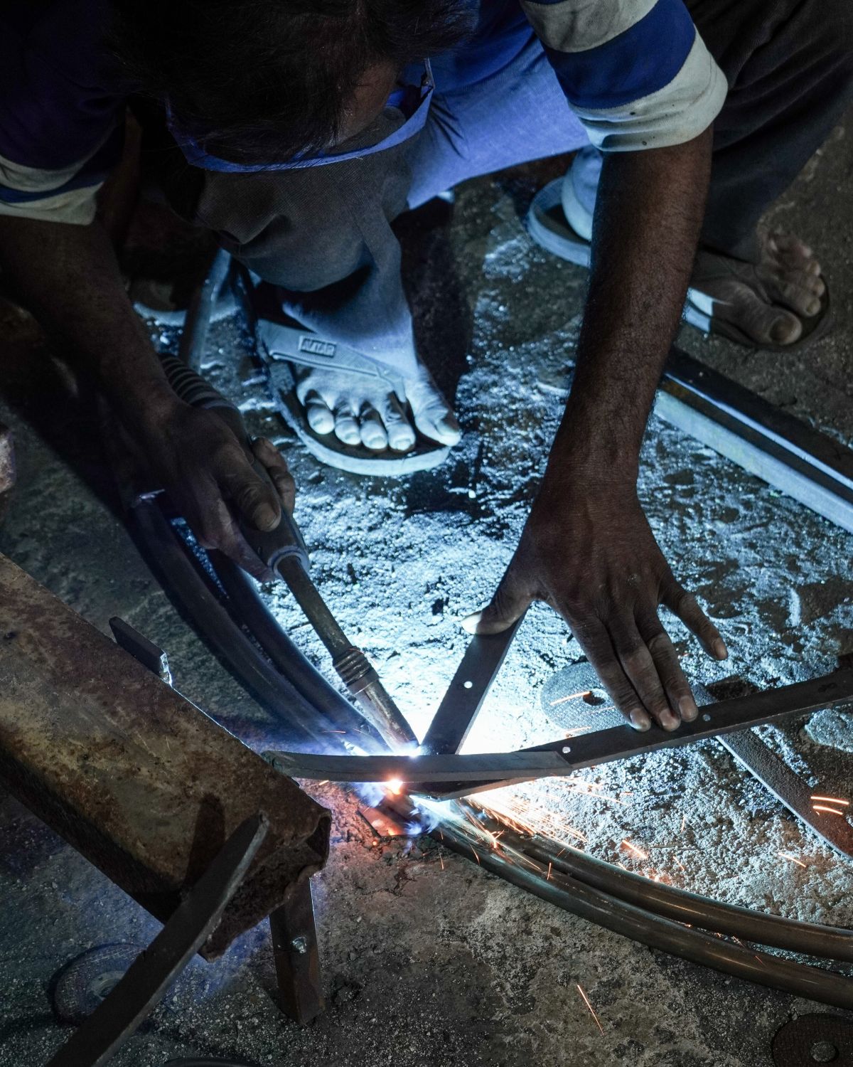 A metal worker welding an iron frame in Bagru